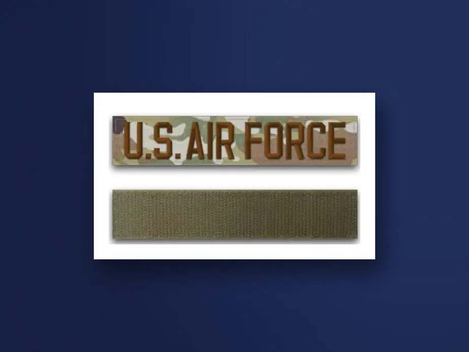 A U.S. Air Force tape embroidered in spice brown on OCP camouflage, with a hook-and-loop strip
